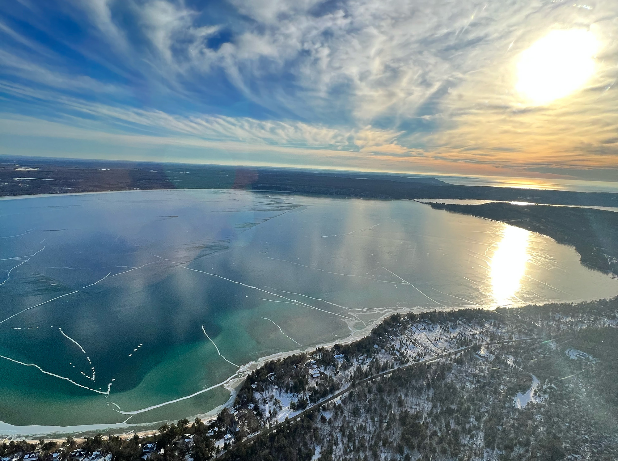 aerial shot of northern Michigan lake during winter